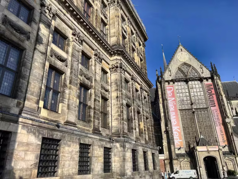 The historic buildings surrounding Dam square feature stunning architectural details creating an impressive urban landscape