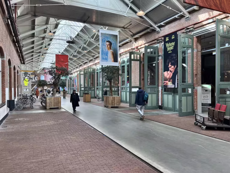 Main hall of the foodhallen in amsterdam. Find your foodbars on your right side of this hall