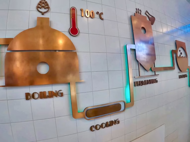 An interactive display illustrates the brewing process at the Heineken experience featuring icons for boiling cooling and fer
