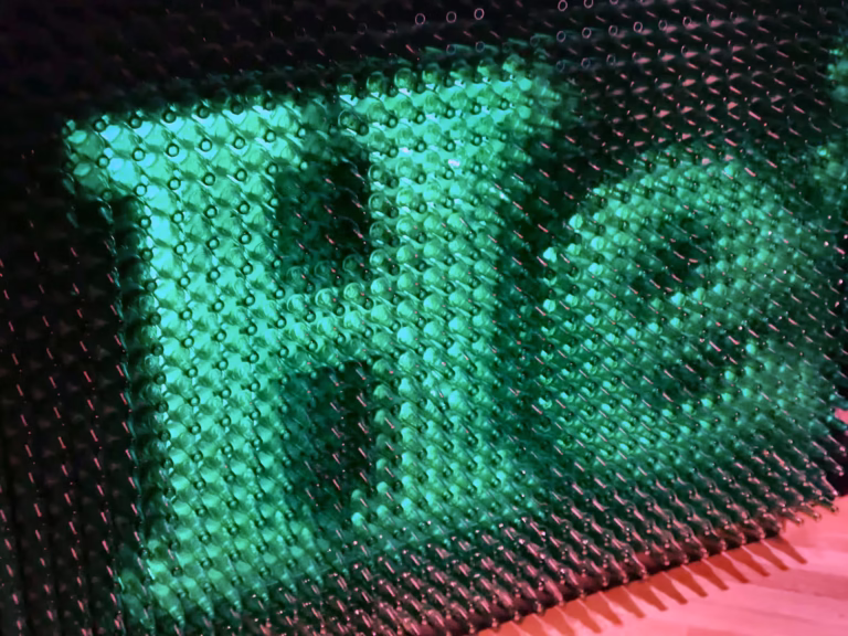 A close-up of the illuminated heineken logo formed by green bottles creating a unique display for the Heineken experience