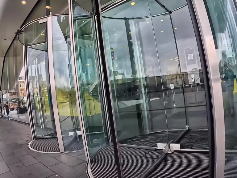 The entrance of the Stedelijk museum features modern glass rotating doors inviting visitors to explore contemporary art